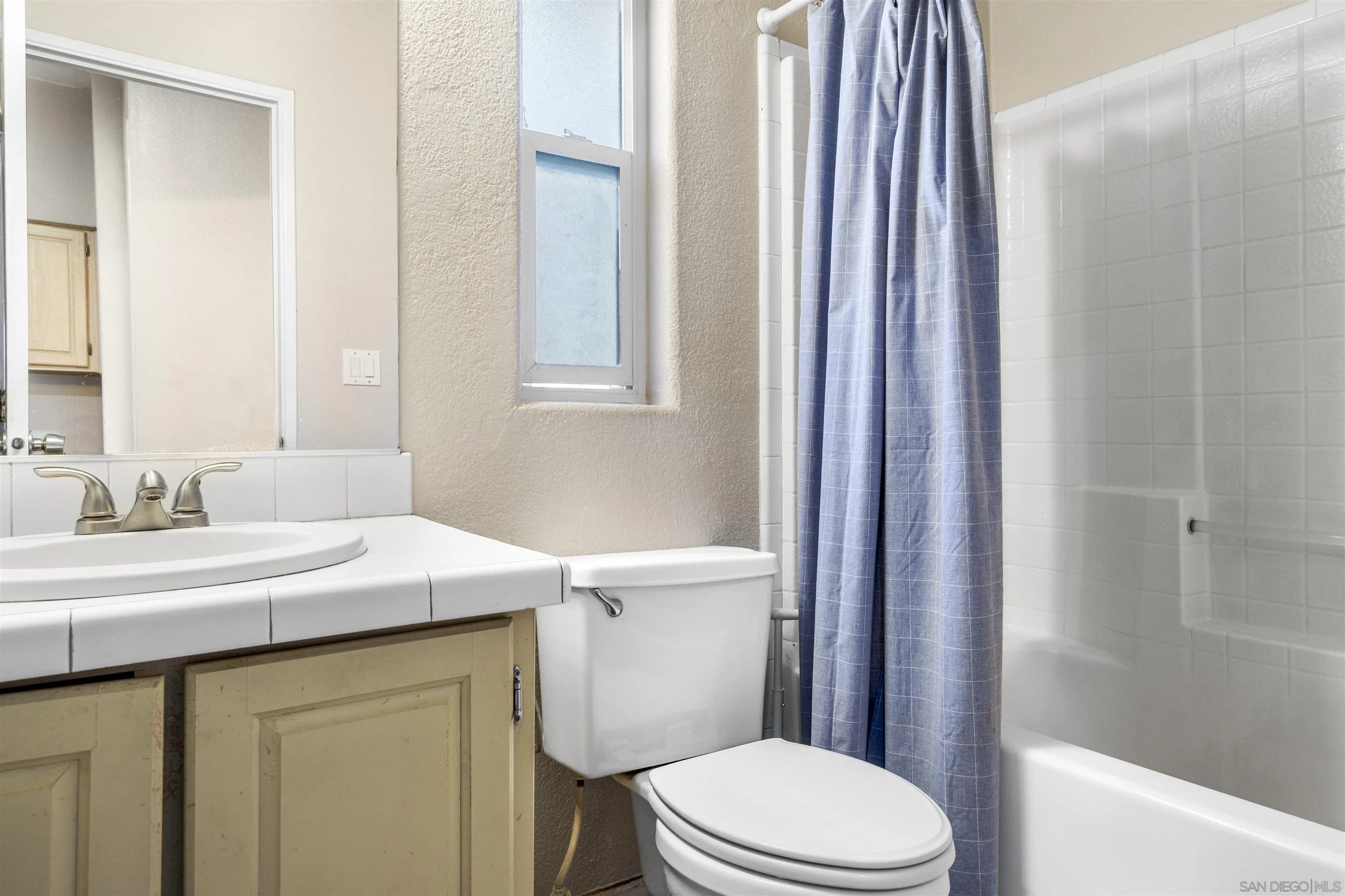 5631 Alpine Boulevard Alpine, CA 91901 - Photo 18 of 20 a bathroom with a sink a toilet a mirror and vanity