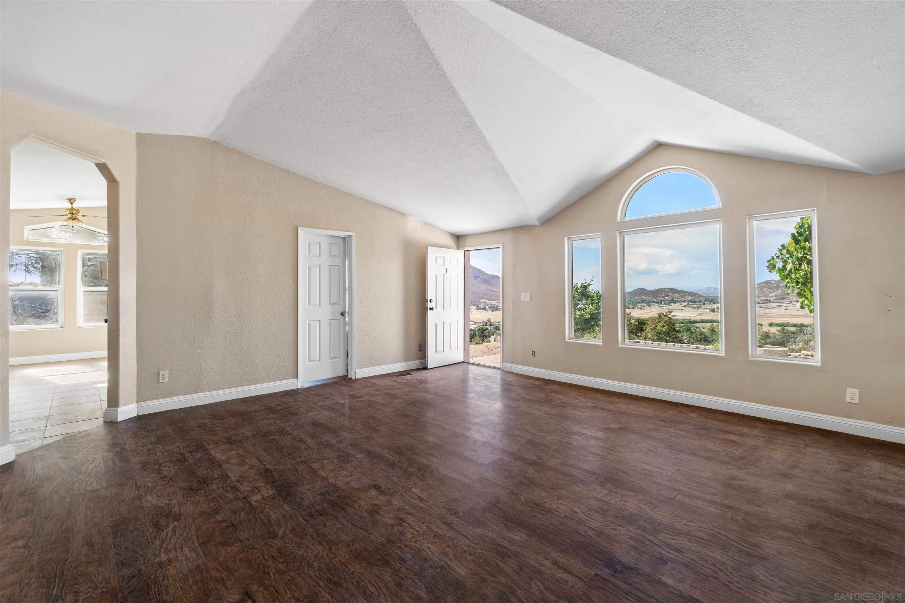 5631 Alpine Boulevard Alpine, CA 91901 - Photo 7 of 20 a view of an empty room with a window and wooden floor