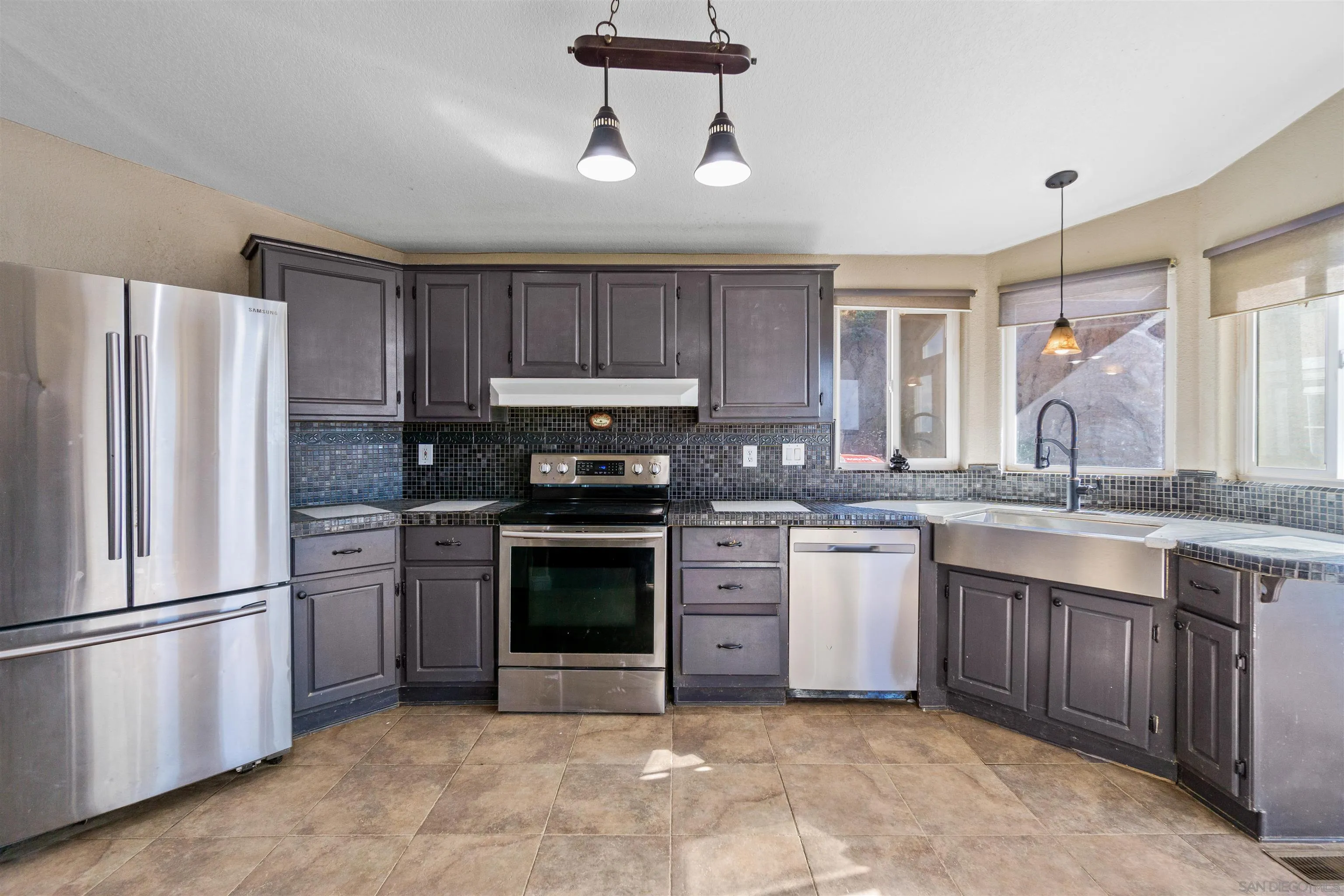 5631 Alpine Boulevard Alpine, CA 91901 - Photo 10 of 20 a kitchen with stainless steel appliances granite countertop a refrigerator a stove a sink and a microwave