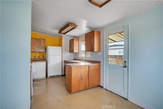 a utility room with cabinets washer and dryer