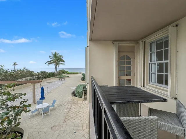 a roof deck with table and chairs