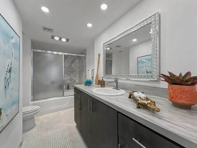 a spacious bathroom with a double vanity sink toilet and shower