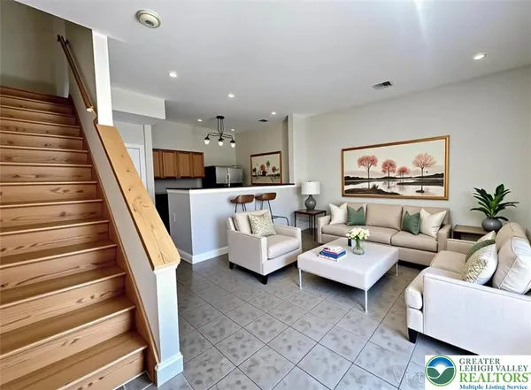 a living room with furniture and a painting