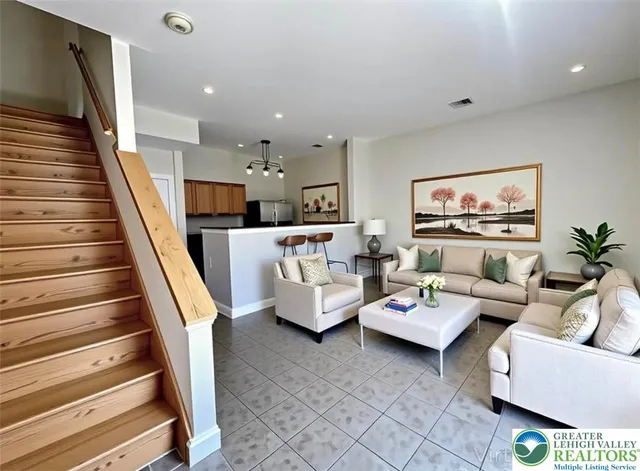 a living room with furniture and a painting