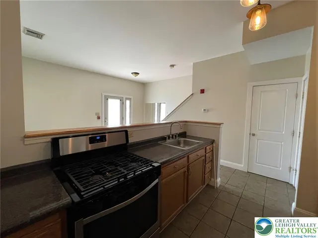 a kitchen with a stove and a sink