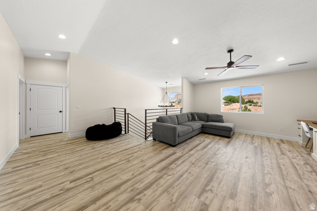 2591 East Washington Dam Road Washington, UT 84780 - Photo 17 of 67 Spacious upper-level area featuring wood-finish flooring, a contemporary ceiling fan, recessed lighting, and a white interior door