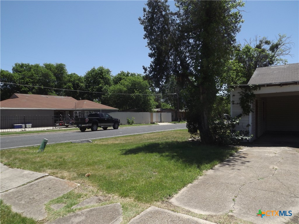 1714 Duncan Avenue Killeen, TX 76541 - Photo 2 of 24 a view of a swimming pool with lawn chairs under an umbrella