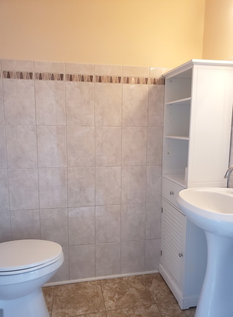 413 Harmony Drive Wheeling, IL 60090 - Photo 16 of 19 a bathroom with a sink a toilet and shower
