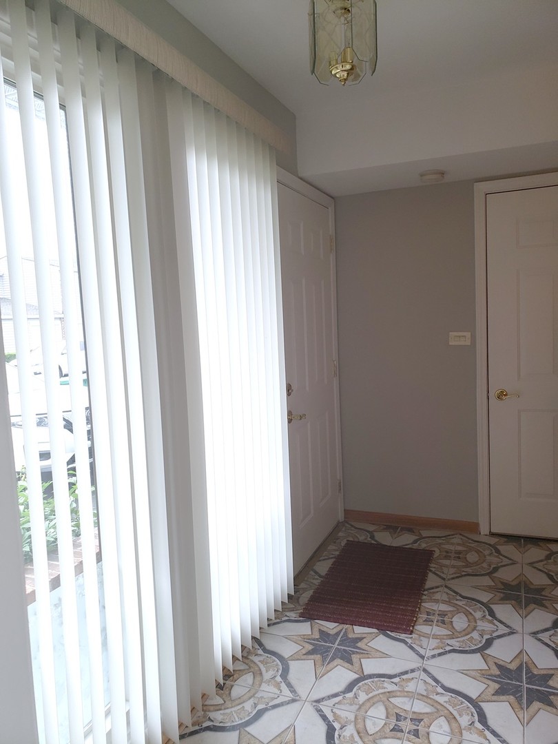 413 Harmony Drive Wheeling, IL 60090 - Photo 2 of 19 a view of an empty room and window