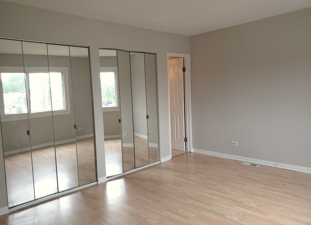 413 Harmony Drive Wheeling, IL 60090 - Photo 5 of 19 a view of an empty room with wooden floor and a window