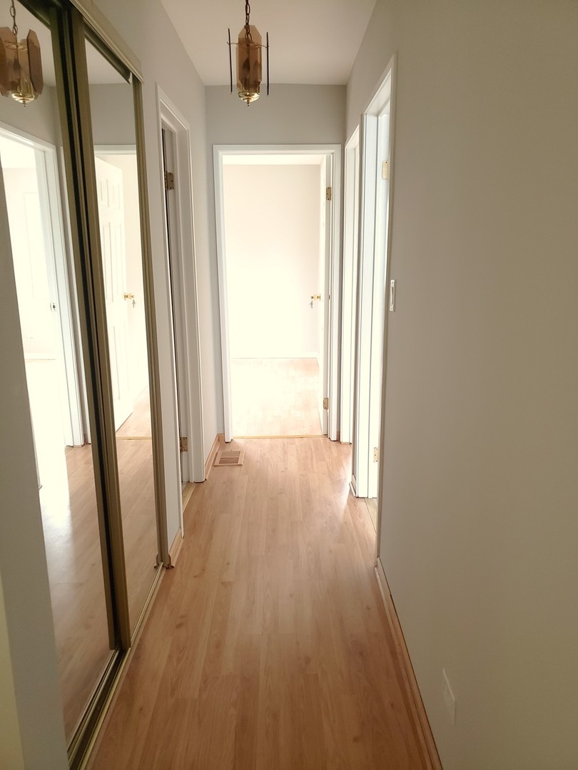 413 Harmony Drive Wheeling, IL 60090 - Photo 9 of 19 a view of a hallway with wooden floor and staircase