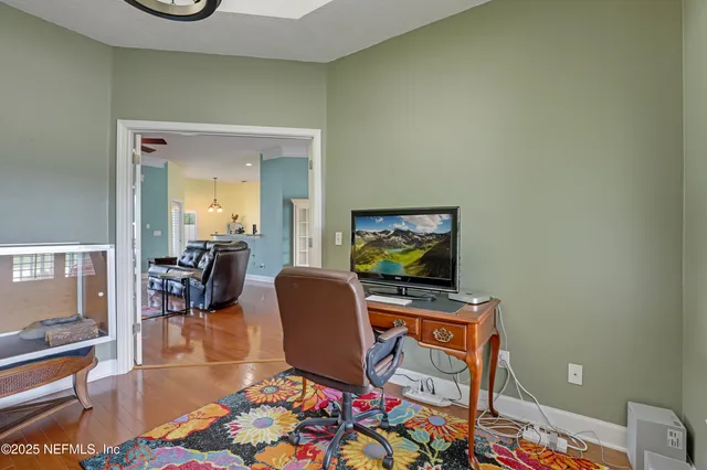a living room with furniture a window and wooden floor
