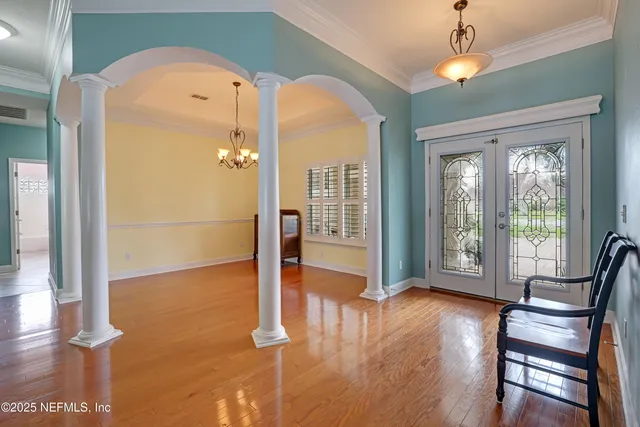 a view of a backyard with table and chairs under an umbrella