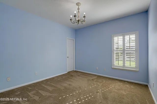 a view of a patio with a table chairs and a backyard