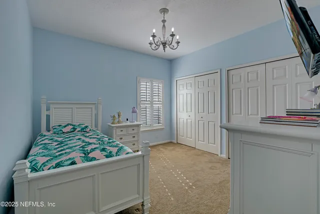 a view of building with river and trees in the background