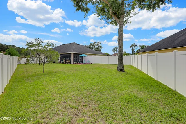 a view of backyard with swimming pool and outdoor seating