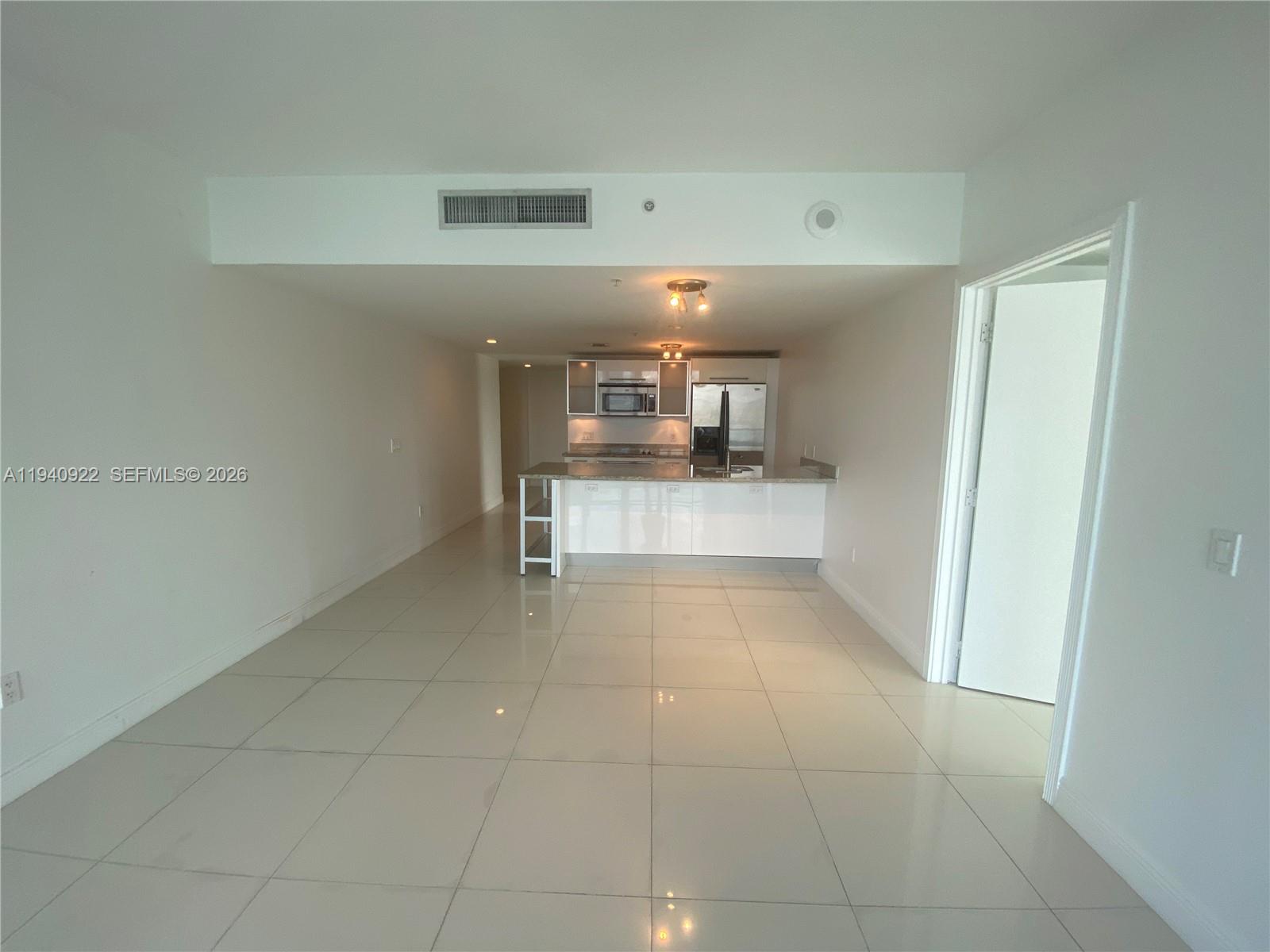 185 Southwest 7th Street, Unit 501 Miami, FL 33130 - Photo 2 of 31 a view of a kitchen with a sink and an empty room