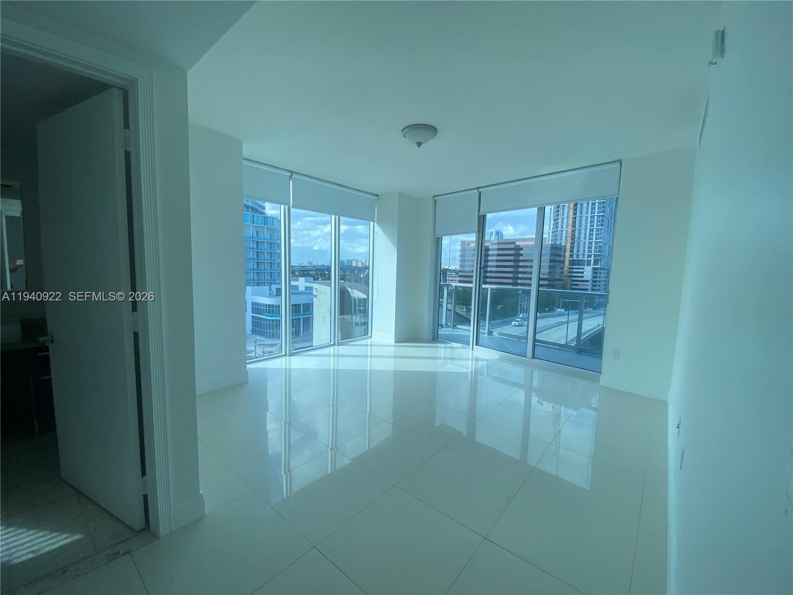 185 Southwest 7th Street, Unit 501 Miami, FL 33130 - Photo 6 of 31 view of an empty room with a window