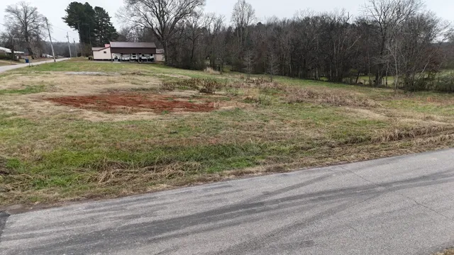 a view of a yard with wooden fence