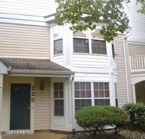 a view of a house with a small space and large windows