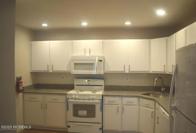 a kitchen with a sink stove and refrigerator
