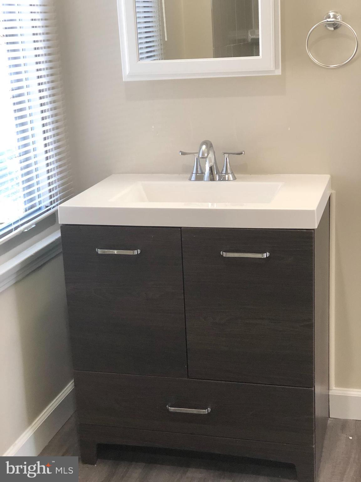 9925 Sutherland Road Silver Spring, MD 20901 - Photo 11 of 15 a bathroom with a sink a vanity and a mirror