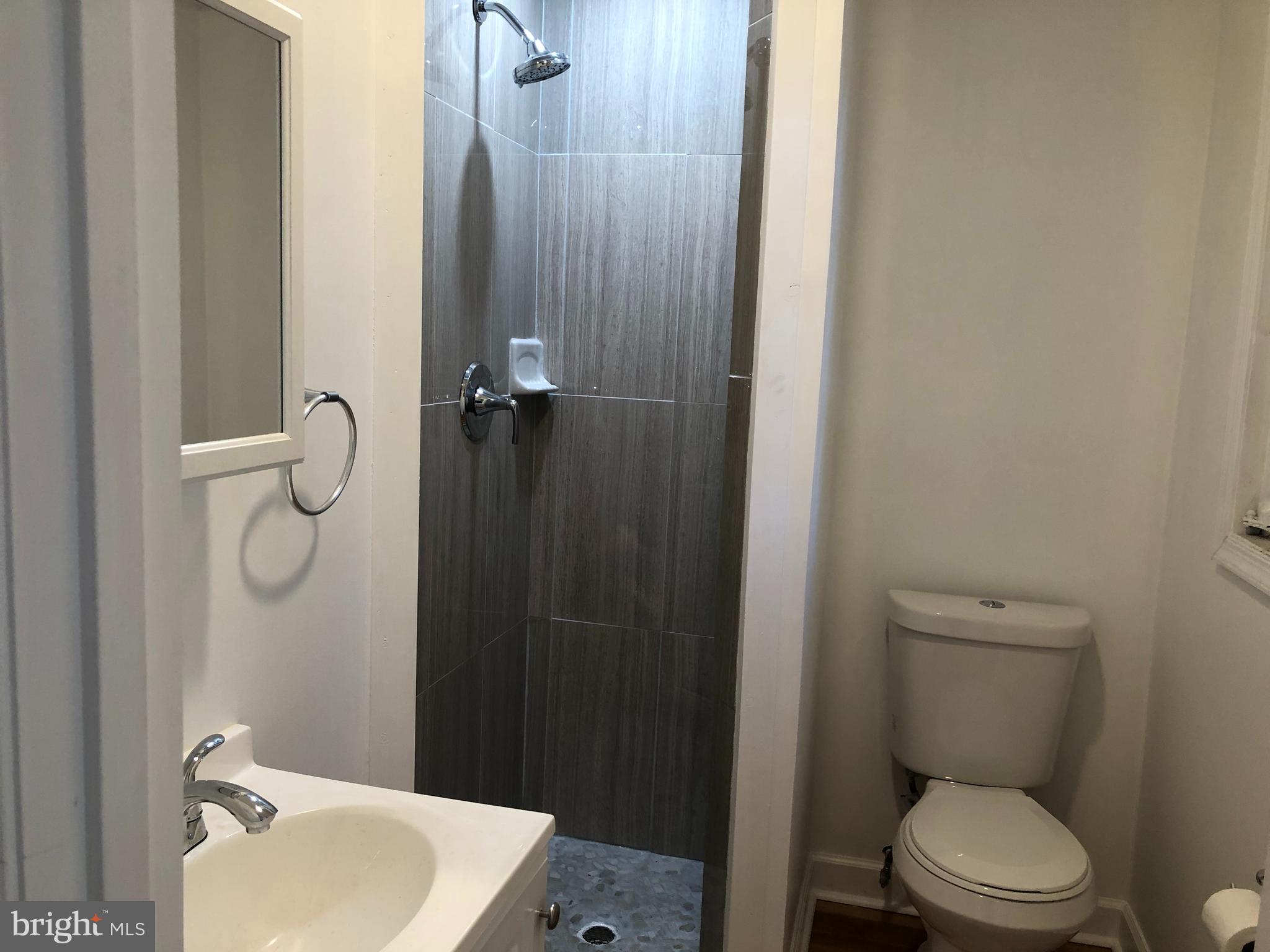 9925 Sutherland Road Silver Spring, MD 20901 - Photo 13 of 15 a bathroom with a toilet a sink and shower