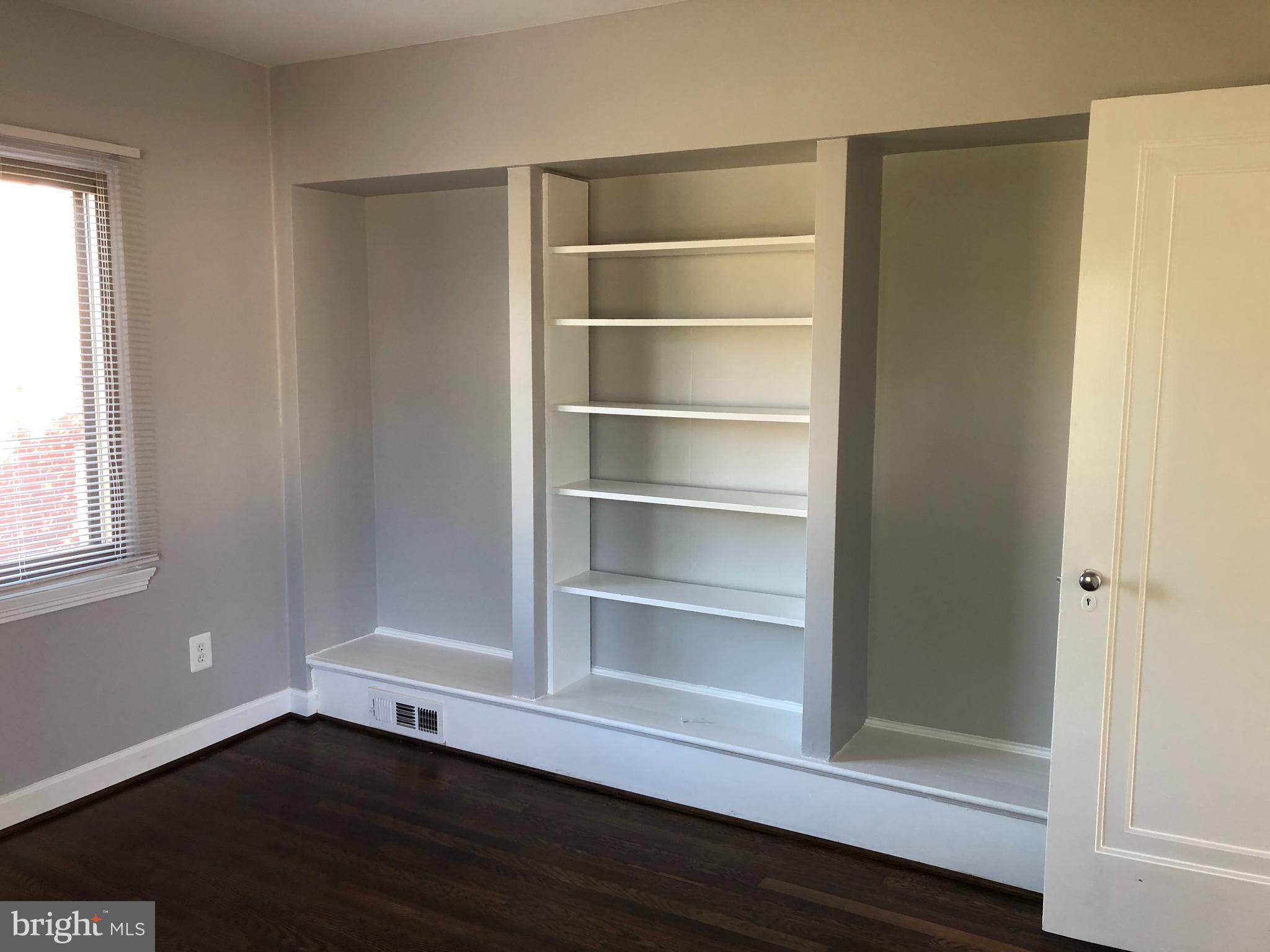 9925 Sutherland Road Silver Spring, MD 20901 - Photo 10 of 15 a view of an empty room with wooden floor and a window