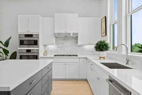 a kitchen with appliances a sink and cabinets