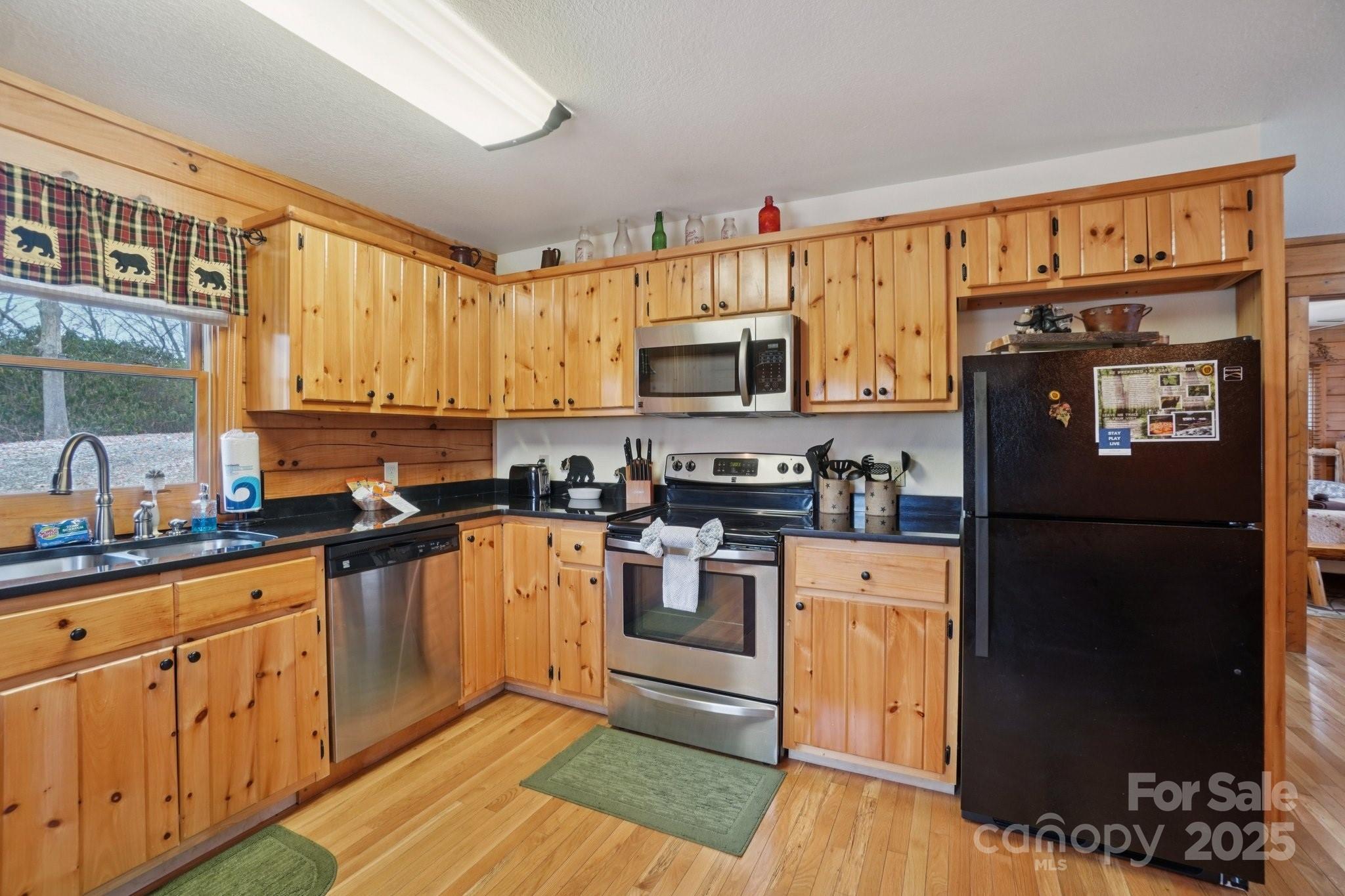 804 Ledbetter Road Robbinsville, NC 28771 - Photo 18 of 27 a kitchen with stainless steel appliances granite countertop a refrigerator stove top oven and sink