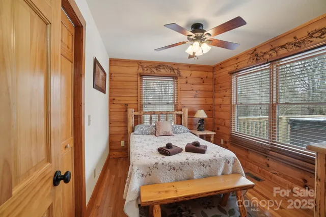 a bedroom with a bed next to a large window