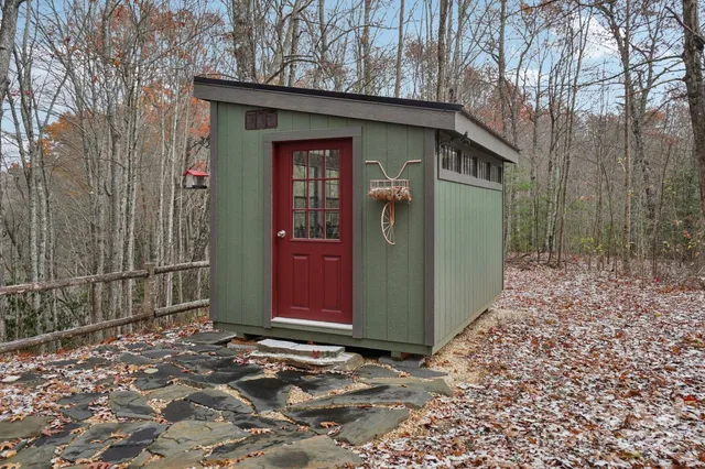 a view of a garden with a chair and fire pit