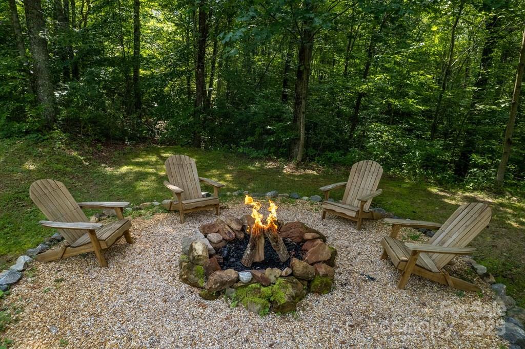 804 Ledbetter Road Robbinsville, NC 28771 - Photo 25 of 27 a view of a garden with a chair and fire pit