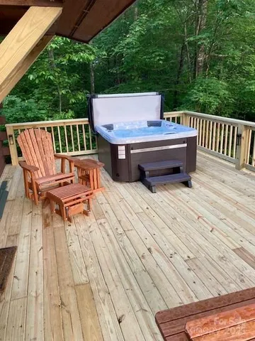 a view of a deck with wooden floor and outdoor seating