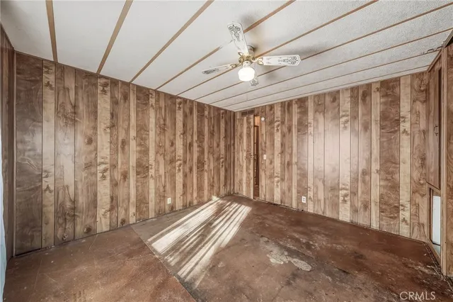 a large kitchen with a wooden floor and cabinets
