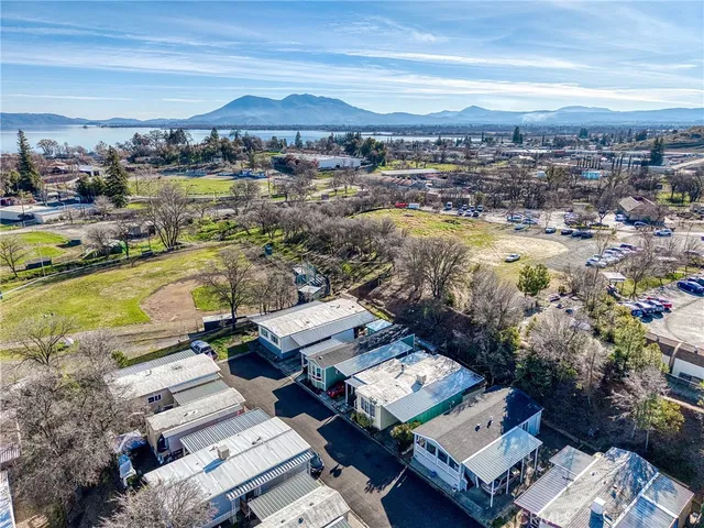 an aerial view of a houses with a lake view