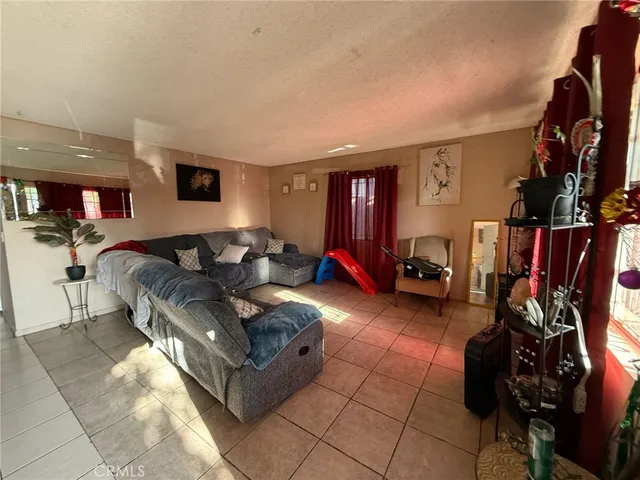 a living room with furniture and a gym equipment