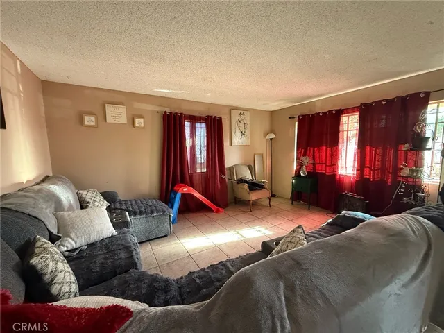 a living room with furniture cabinets and a window