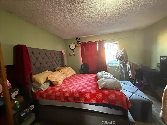 a bedroom with bed and window