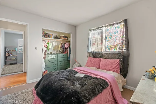 a bed sitting in a bedroom next to a window