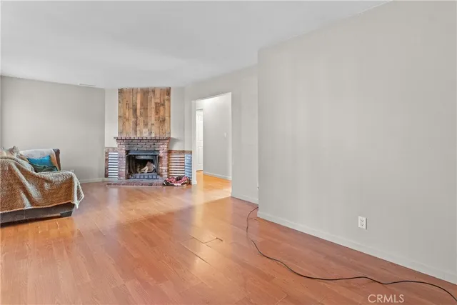 an empty room with furniture and a fireplace