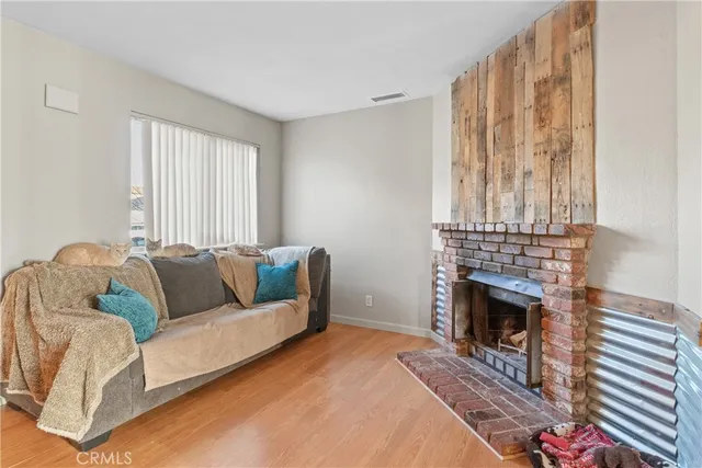 a living room with furniture a fireplace and a table