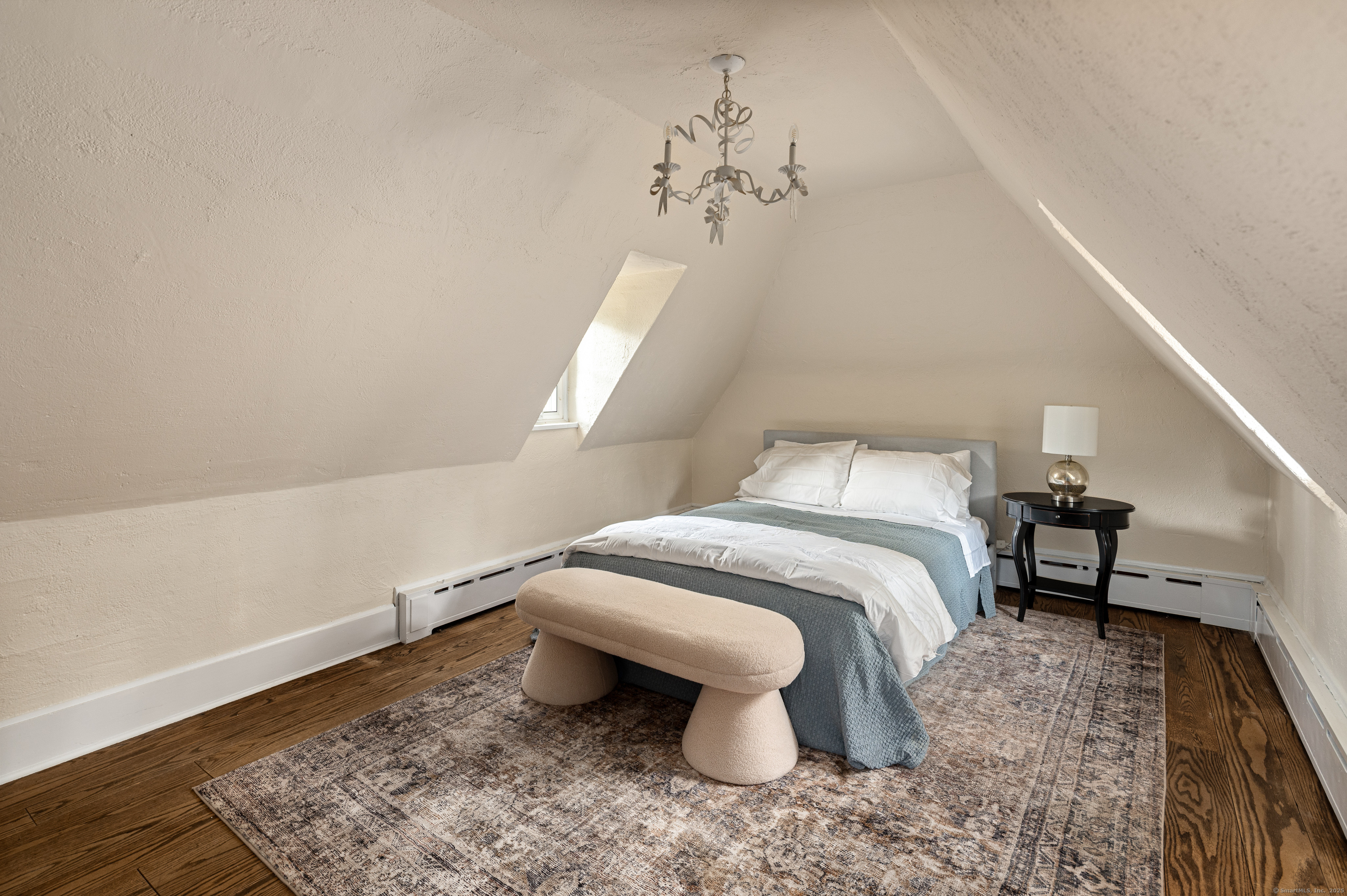 271 Hunting Ridge Road Stamford, CT 06903 - Photo 32 of 40 a bedroom with a bed and a chandelier