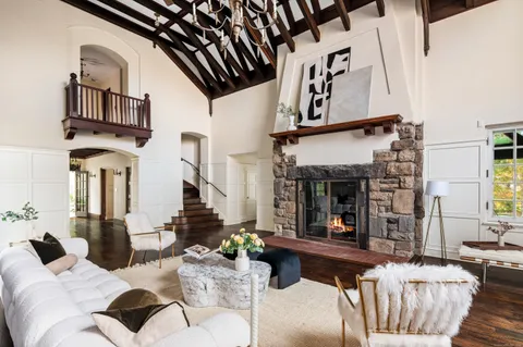 a living room with furniture and a chandelier