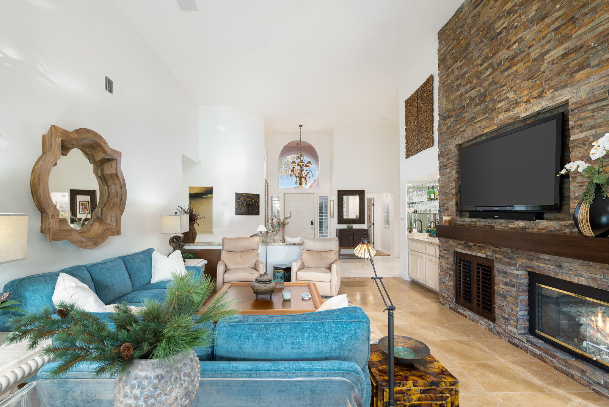 56685 Merion La Quinta, CA 92253 - Photo 24 of 82 a living room with furniture a flat screen tv and a fireplace