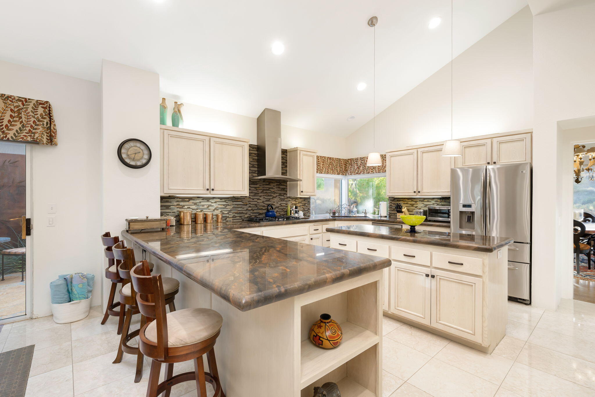 56685 Merion La Quinta, CA 92253 - Photo 36 of 82 a kitchen with a sink a stove a refrigerator and cabinets