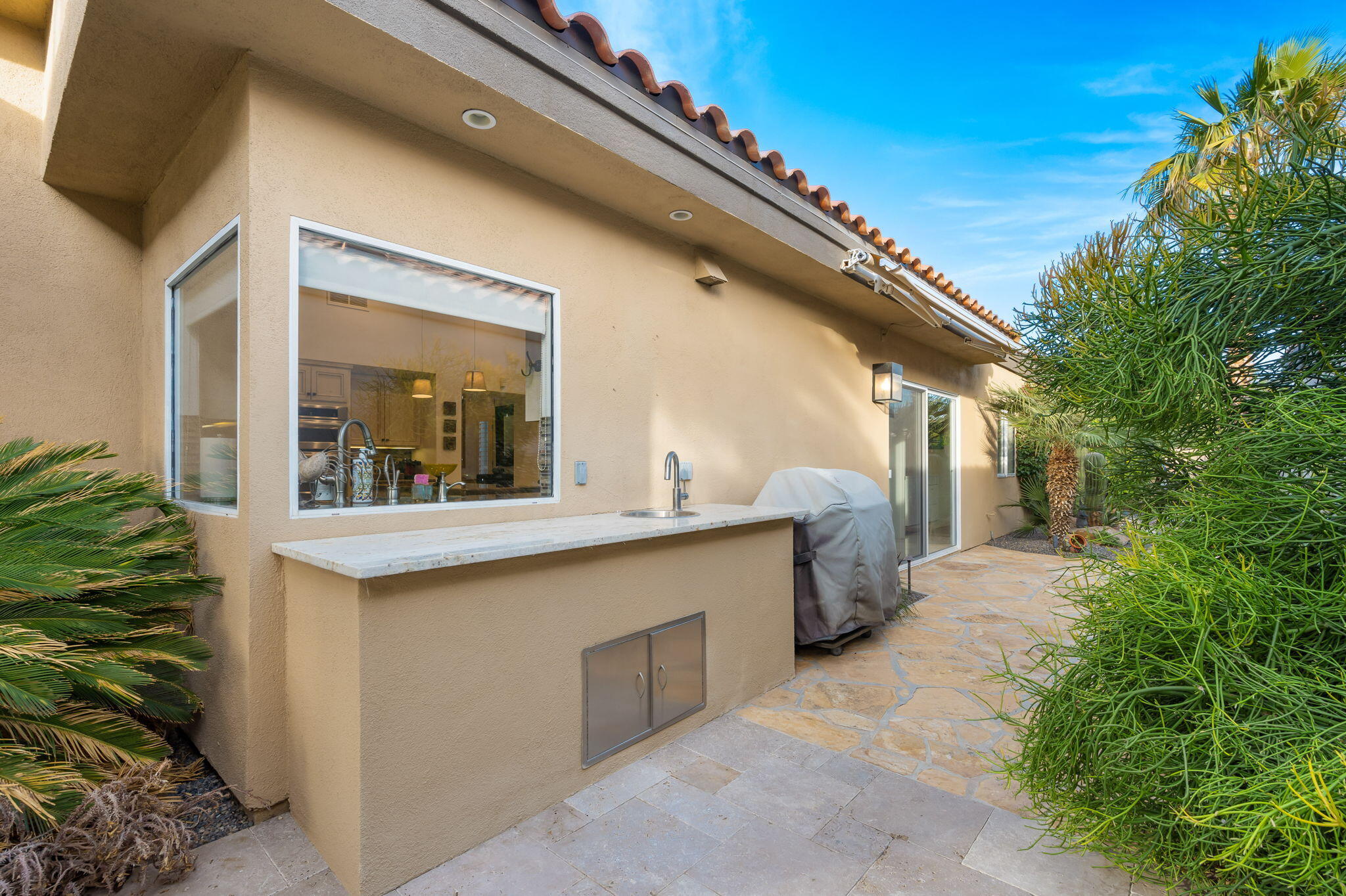 56685 Merion La Quinta, CA 92253 - Photo 56 of 82 a view of a kitchen with a sink and dishwasher a fireplace with wooden floor