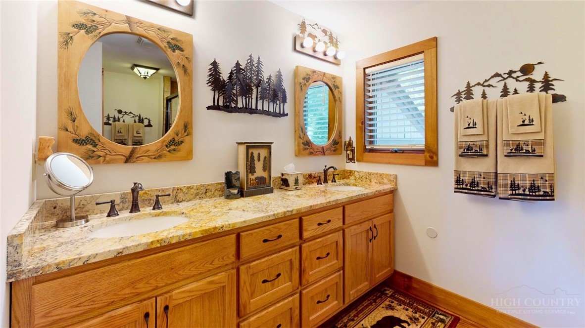 250 Ridgeview Road, Unit 43 Sugar Mountain, NC 28604 - Photo 14 of 21 a en suite bathroom with a double vanity sink and a mirror