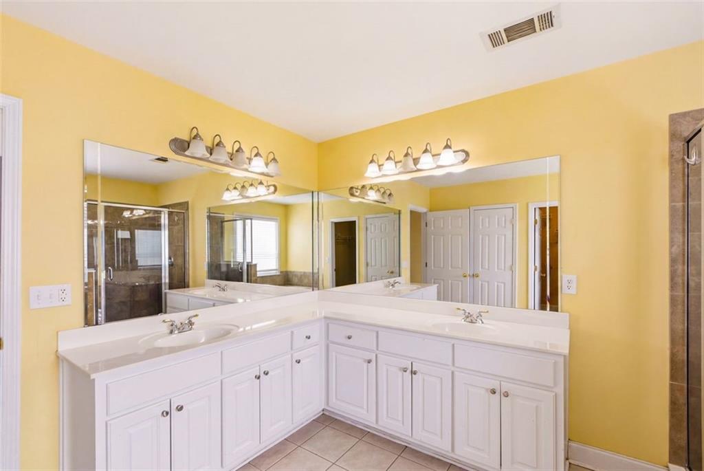 3420 Bulloch Lake Road Loganville, GA 30052 - Photo 38 of 57 a spacious bathroom with a double vanity sink and a mirror