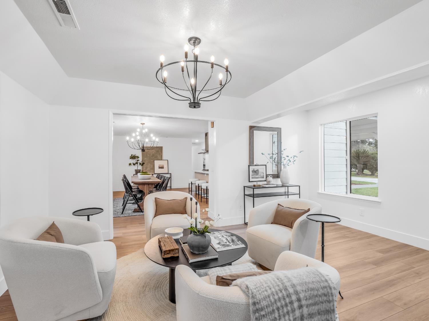 7284 West Rialto Avenue Fresno, CA 93723 - Photo 11 of 60 a living room with furniture chandelier and a window